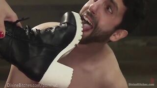 The muscled dominatrix wears leather to dominate her slaveboy in doggy style