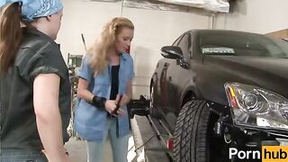 The girl is having fun with the lesbian in the garage