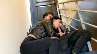 A couple has fun on the stairs of their apartment