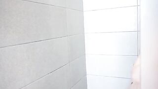 A guy spies on his stepsister as she plays with her pussy in the shower