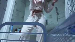 A petite girl with an amazing body masturbates her pussy in the bathroom