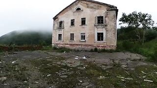 An exhibitionist girl walks through abandoned buildings, getting intimate in public
