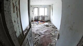 An exhibitionist girl walks through abandoned buildings, getting intimate in public