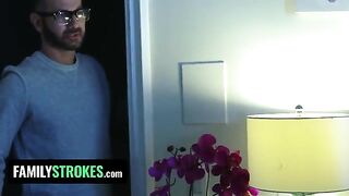 The stepdaughter pleasures her stepdad while her stepmom is in the room