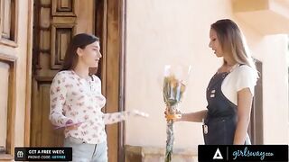 The girl is rubbing flowers for the sake of a cute brunette