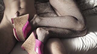 A sexy girl caresses her guy through fishnet stockings and high heels