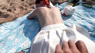 A couple has sex on the public beach, enjoying the thrill of being caught
