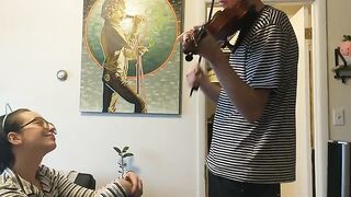 The couple was interrupted while the girl was trying to practice her violin