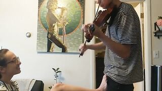 The couple was interrupted while the girl was trying to practice her violin