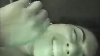 A brunette woman fucks at home in the bedroom, showcasing her natural tits