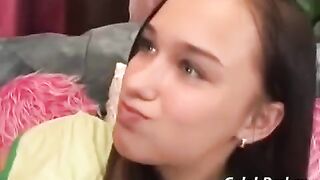 A cute young girl has sex with an adult guy on the couch