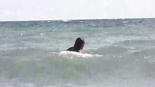 Two girls sunbathes naked on the beach, enjoying a sensual day