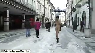 A hot student with big boobs walks outside and lifts her shirt up to show her tits
