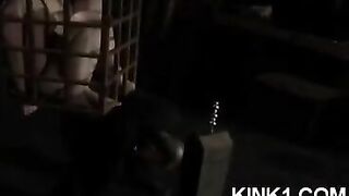 A slave in a cage is forced to fulfill all the orders of his master