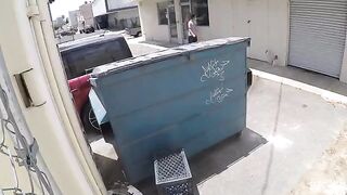 A hot chick was photographed getting intimate behind the garbage tank