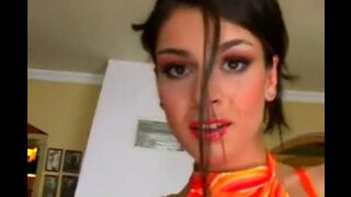 A woman in a leather suit masturbates herself on the chair
