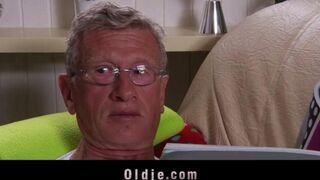 A hot blonde has sex with an older gentleman on the couch