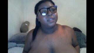 A black woman closed the camera while showing off her big natural tits