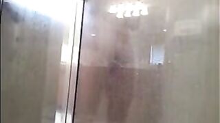 A man washing his body in the shower, cam filming