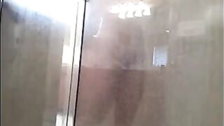 A man washing his body in the shower, cam filming