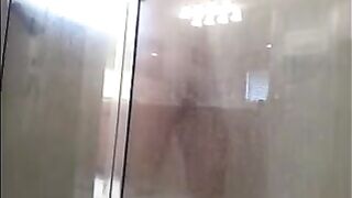 A man washing his body in the shower, cam filming