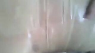 A guy puts a condom on his dick and masturbates it