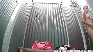 A girl washes her body in the shower, unaware of being watched