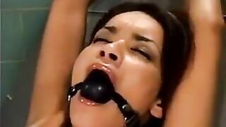 A bald guy gets a girl on a sex machine and fucks her