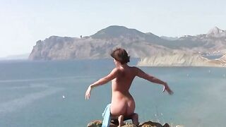 A young girl poses naked on the beautiful beach