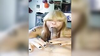 Black woman carefully takes a member in her mouth with condom