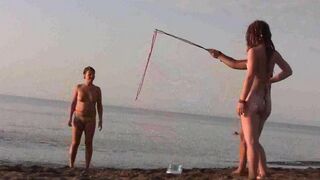 Nudist beauties have fun on the sandy beach