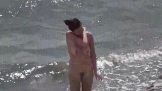 A couple of free-spirited lovers enjoy each other on the naked beach