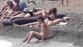 A couple of free-spirited lovers enjoy each other on the naked beach