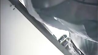 The employee secretly shoots chicks at the checkout, lifting their skirts