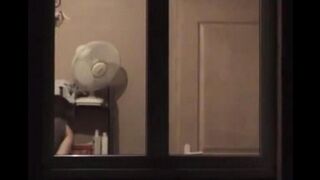 He admires himself in the mirror, standing in front of it completely naked