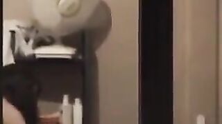 He admires himself in the mirror, standing in front of it completely naked