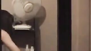 He admires himself in the mirror, standing in front of it completely naked