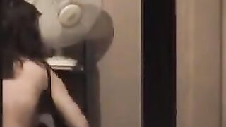 He admires himself in the mirror, standing in front of it completely naked