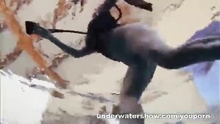 A sexy girl is floating naked in the pool, creating a sensual video
