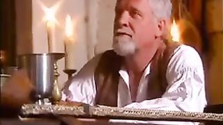 Girl in medieval clothes has sex with her lover on the sofa