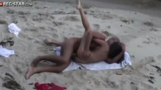 A couple has sex on the beach with a hidden camera