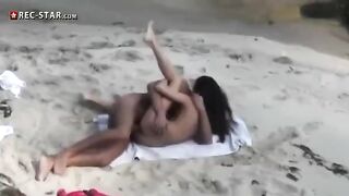 A couple has sex on the beach with a hidden camera