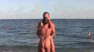 A group of naked gymnastics enthusiasts have a lot of fun on the beach