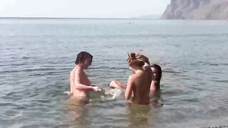 Nudist beauties enjoy outdoor sex on the sandy beach, captured in stunning detail