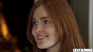 The guy carefully licks the red-haired woman's moustache