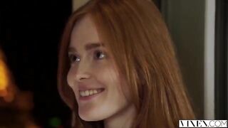 The guy carefully licks the red-haired woman's moustache
