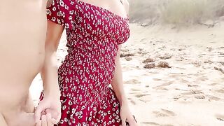 A couple has sex on the beach, enjoying a romantic and risky encounter under the open sky, with the woman using her charm to make her partner cum inside her