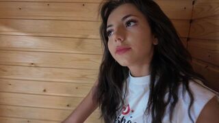 A sexy brunette gets intimate in the sauna